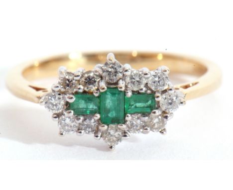 An emerald and diamond cluster ring, centring three small stepped cut emeralds within a small diamond set surround, stamped 7