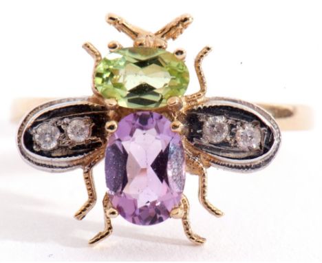 Modern 9ct gold insect ring, the head set with an peridot and an oval amethyst body with diamond set outstretched wings, size