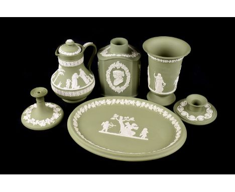 A large collection of green Wedgwood Jasperware, comprising a large bowl, table lighter, jugs, chamber sticks, lidded pots an