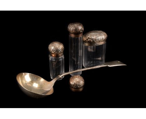 A three Victorian silver topped bottles,  with faceted bodies and a silver plated ladle, London 1889