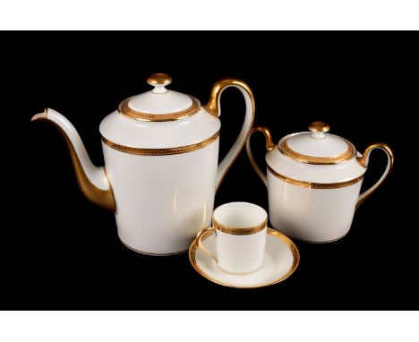 A 12 setting Limoges coffee can set, in white with gilt rim and gilt arrow head patterned border, 12 cans and saucers, coffee