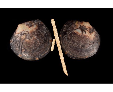 A pair of 19th century carved souvenir shells, from the French collectivity of New Caledonia in the south west Pacific, dated