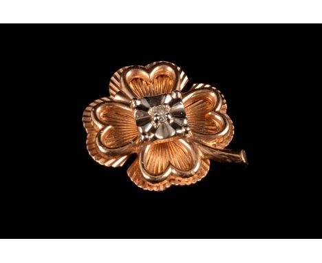 An American 10K gold and diamond tie pin,  modelled as a four leaf clover, centred with a eight cut diamond, cased in a Harri