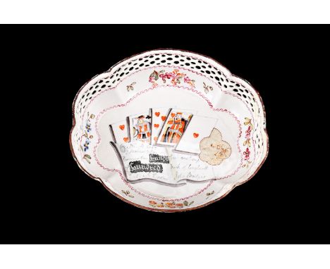 A 19th century Staffordshire enamel dish, of reticulated serpentine form, the reserve decorated with playing cards and money 