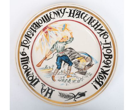 Rare Soviet Russian Porcelain Propaganda Plate by Rudolf Feodorovich Vilde, plate depicting a Bolshevik worker heroically com