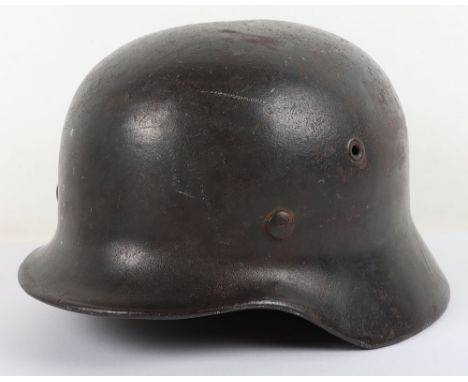 WW2 German Armed Forces M-40 Steel Combat Helmet, retaining much of its original dark combat paint finish to the exterior and