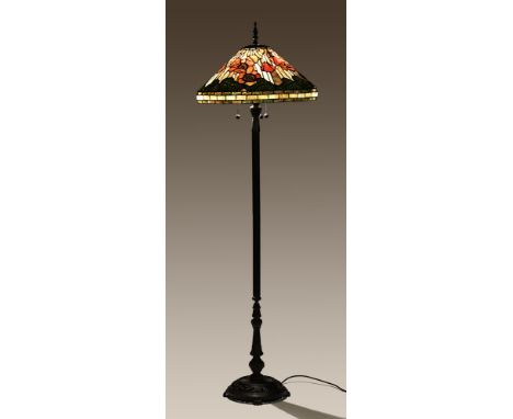 A 20th century Tiffany style standard lamp, the glazed shade decorated with poppies, with a reeded column and pierced base. H