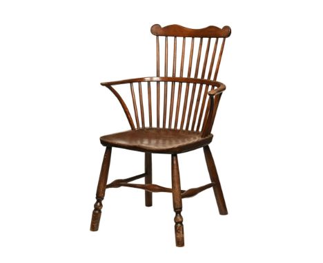 A 19th century yew wood comb back Windsor armchair, with solid shaped seat and raised on splayed turned legs.  Height to top 