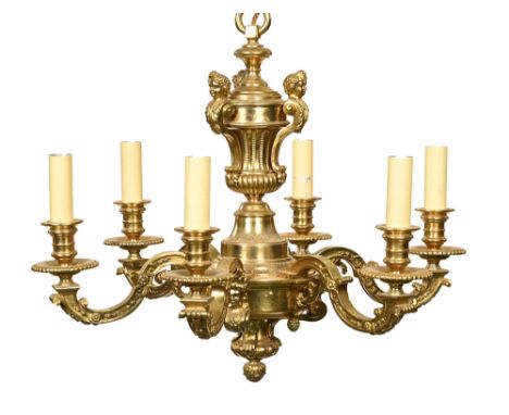 A brass six branch ceiling light fitting, the central column decorated with three figureheads and an urn shape.  Height +/- 5