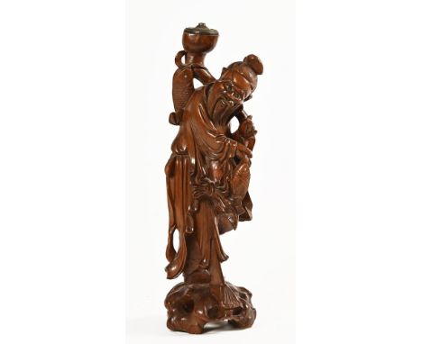 A Chinese figure of a fisherman, hardwood with light fitting to top. Height 49 cm.
