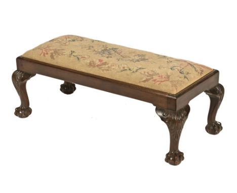 A mahogany framed rectangular footstool, with tapestry top raised on short cabriole legs with carved knees and claw and ball 