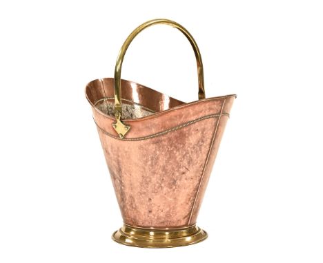 A late Georgian brass and copper coal helmet, with border beadwork decoration.  Height excluding handle 39.5 cm.