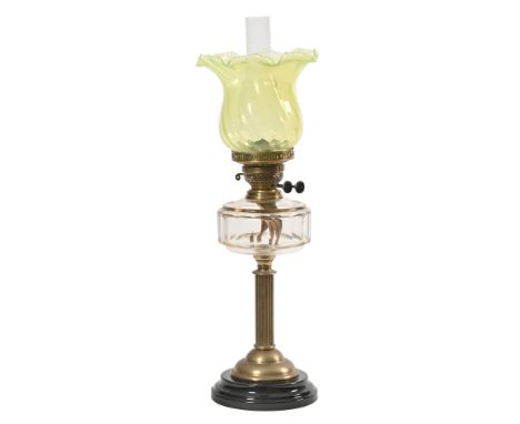 A Victorian oil lamp with black glass base, brass reeded column clear glass reservoir and Vaseline glass shade.  Height 59.5 