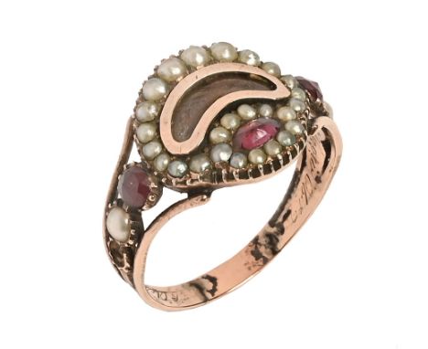 A Georgian mourning ring, gold coloured with seed pearl and purple coloured stones, the inner shank engraved but illegible. +