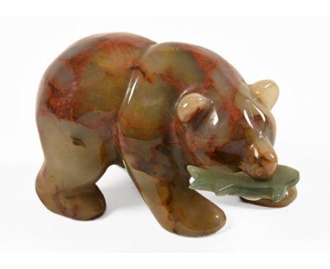 A carved Inuit jade or hardstone bear with salmon.  Height +/- 4.5 cm, length 7.5 cm.