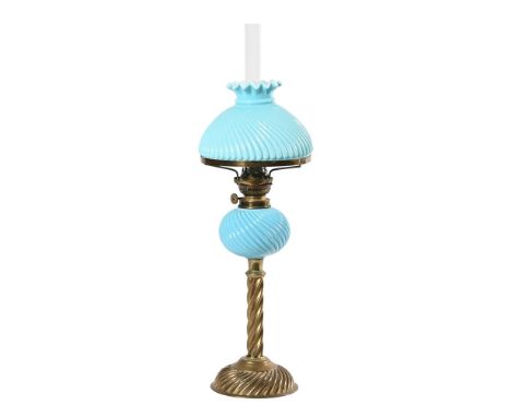 A Victorian brass and blue glass column oil lamp, with twisted blue glass reservoir and shade. Height excluding chimney 51 cm