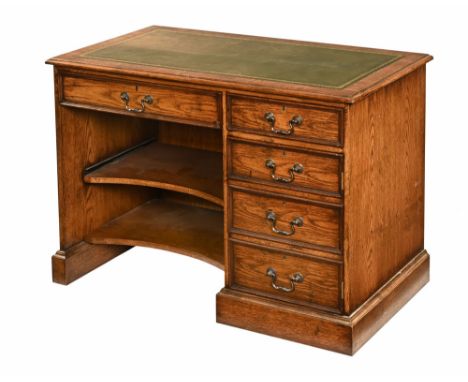 A modern oak desk, with green and gilt tooled leather top with a long drawer to the left-hand side with retractable shelf and