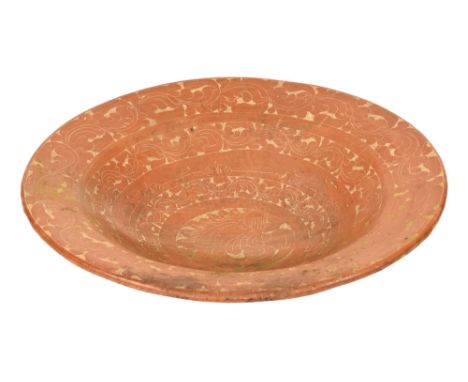 A ceramic bowl with floral terracotta coloured decoration.  Height 10 cm, diameter 48 cm.