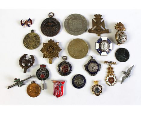 A quantity of military and other badges, medals, pins etc, including Winchester and District football League.