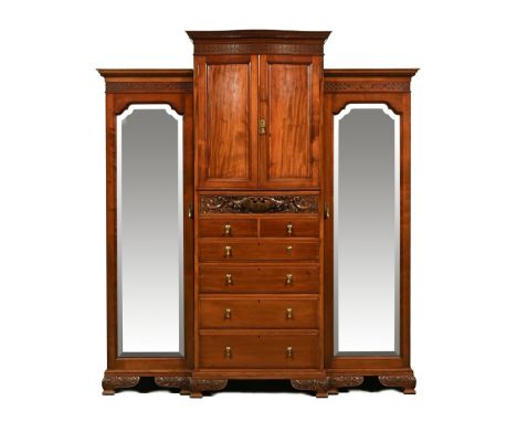A fine quality Edwardian mahogany wardrobe, fitted with a series of cupboards drawers secret drawers mirrored doors enclosing