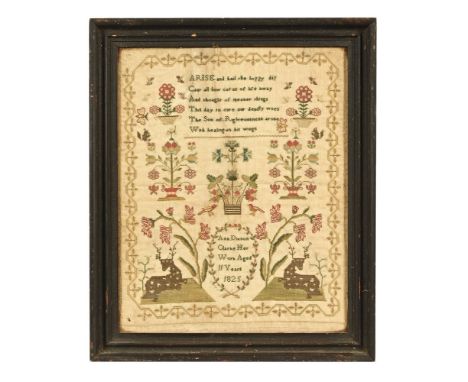 A sampler by Ann Dixon Clarke aged 11 years 1825, with stags and religious script.&nbsp; 37 x 29 cm, framed.