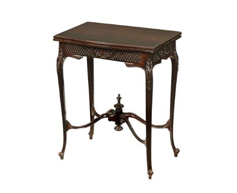 An Edwardian mahogany turnover top games table, with blind fretwork carved frieze and raised on carved cabriole legs terminat