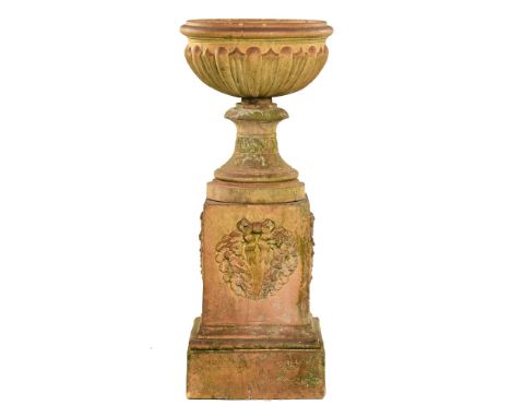 A large late 19th century terracotta urn, on pedestal stand, with half lobed body and on square stepped base. Height 134 cm, 