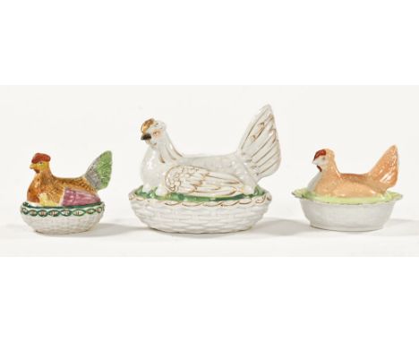 A collection of three 19th century ware hen on nest egg cruets.  Largest length 20 cm, height 16 cm.The tailer of the beige c