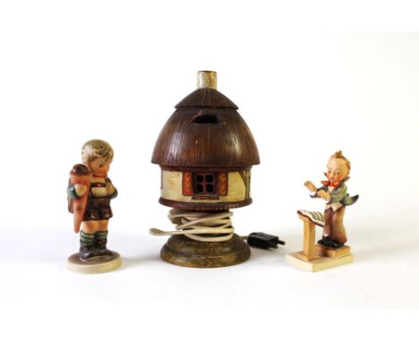 Two Hummel figurines.  Tallest 14 cm, together with a carved wooden night light of similar style.  Height 22 cm.