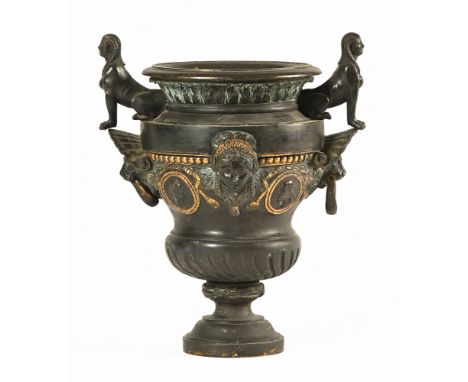 A French Empire bronze urn vase, the handles with sphinx decoration with lion mask handles. Height 28 cm.The urn is generally