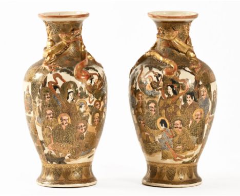 A pair of Satsuma vases, decorated with dragons Samurai etc. Height +/- 24 cm.The first vase is generally in very good order,