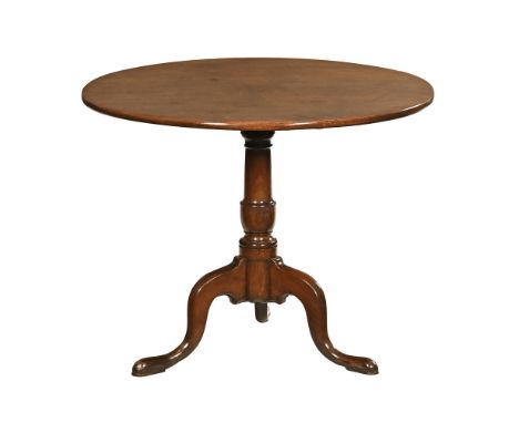 A George III mahogany snap top tripod table, with turned centre column and three downswept legs terminating in pad feet.  Hei
