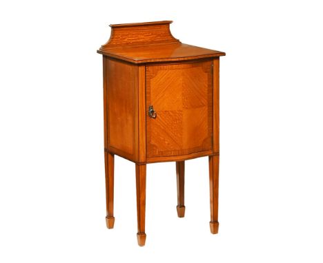 A fine quality Edwardian inlaid satinwood bedside cabinet, with rear upstand and serpentine fronted door opening to shelves a