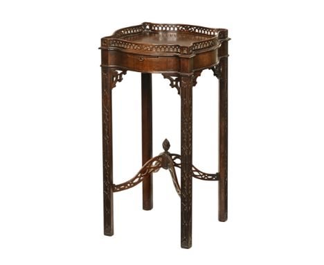 A 19th century mahogany blind fretwork carved urn stand, with pierced gallery candle slide and moulded legs united by raised 