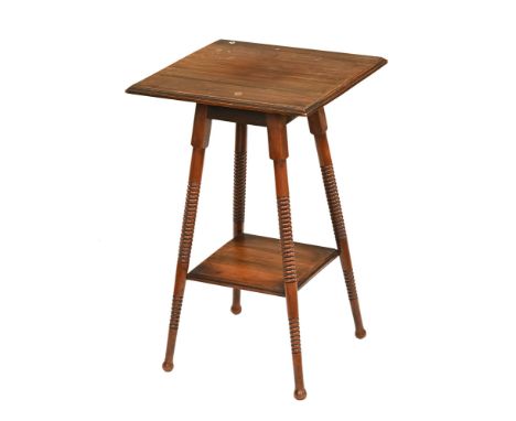 An Edwardian Liberty style walnut occasional table, with square top raised on four turned legs united by a shelf.  Height 71 