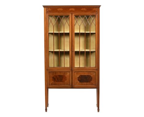 An Edwardian inlaid mahogany display cabinet, with moulded blind dentil cornice above a pair of partially glazed and panelled