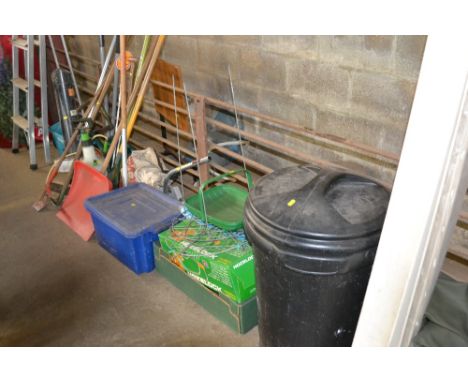A large quantity of gardening items to include long handled gardening tools, Ryobi  - lacking lead, seed spreader, Hoselock, 