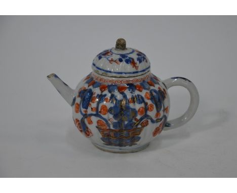 An 18th century Chinese export Imari teapot, Kangxi period (1662-1722) with fluted globular body and cover decorated with a f