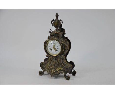 A rococco style gilt brass cased eight day table clock, the eight-day two train movement by A D Mougin with convex white enam