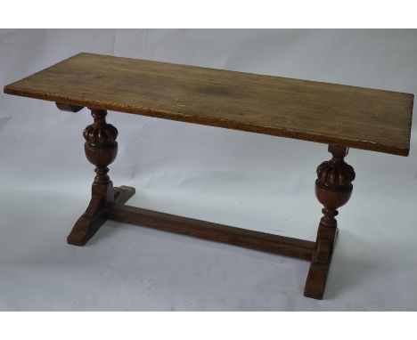 A 17th century style oak refectory dining table, the rectangular top raised on bulbous moulded supports united by a square ce