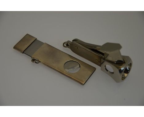William Manton - Two silver cigar cutters, one plain with guillotine action, the other with engine turned decoration (2)No ob