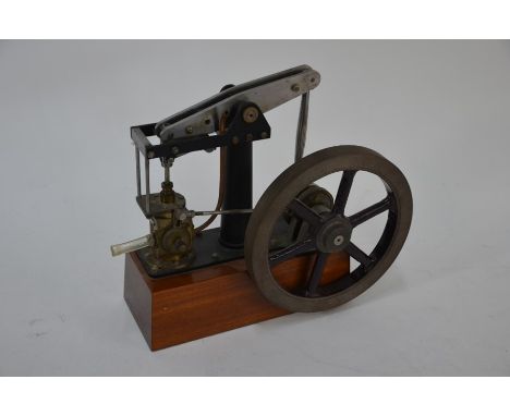 A good scale model beam engine, matt black finished with 15.5 cm dia. on wood plinth, 22 cm x 9.5 cm o/all