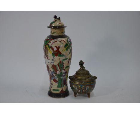 A late 19th century Chinese famille rose vase and cover with guardian lion finial, decorated in polychrome enamels with a nar