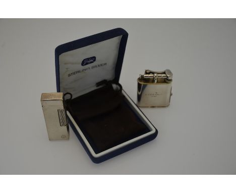 Dunhill - An engine turned electroplated rollagas cigarette lighter, no 17893, in velvet pouch to/w an electroplated table ci