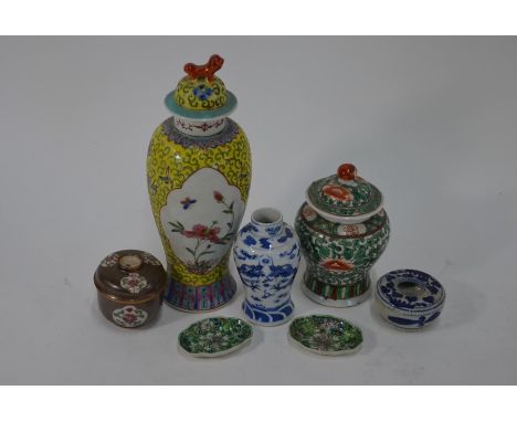 A small collection of Chinese ceramics; a 19th century famille rose yellow ground vase and cover with lion finial, decorated 