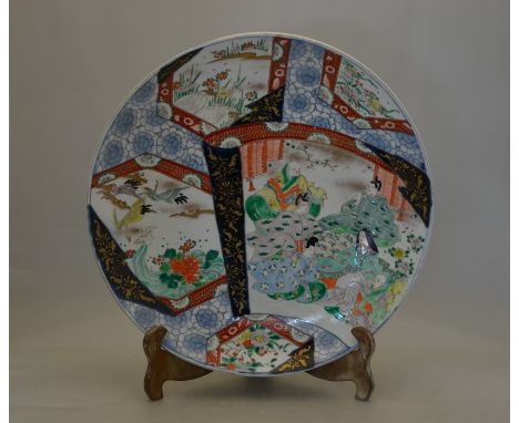 An unusual Japanese Meiji period (1868-1912) Imari charger, decorated in typical underglaze blue, polychrome enamels and gild