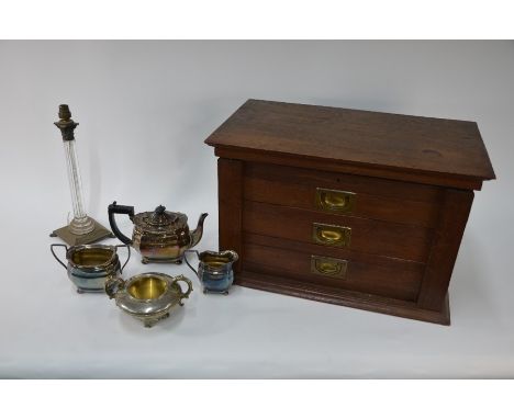 An oak canteen with hinged top and three drawers containing a quantity of mixed electroplated flatware, small amount of silve