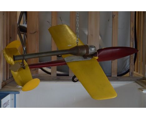 A painted wood model aeroplane with rocket engine, 92 cm long x 82 cm wingspan