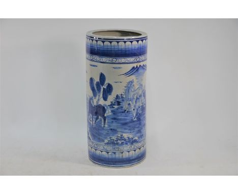 A 20th century Chinese blue and white cylindrical stick stand painted with horses and a continuous landscape scene in tones o