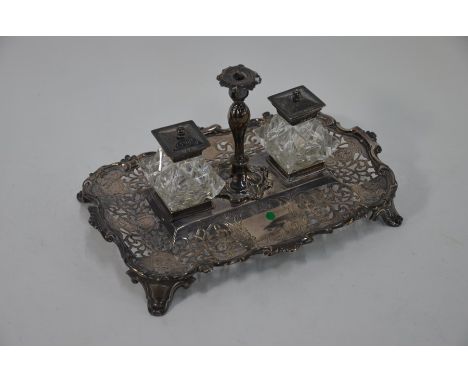 A Victorian silver inkstand with engraved and pierced decoration, scroll borders and bracket feet, fitted with detachable tap